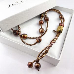 Long gemstone jewelry with gold colored hematite and true pearls